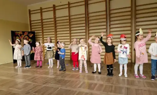 dzieci prezentują przed gośćmi piosenkę Przyszła jesień do parku