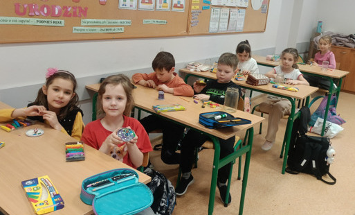 uczniowie w ławkach pracują z plasteliną