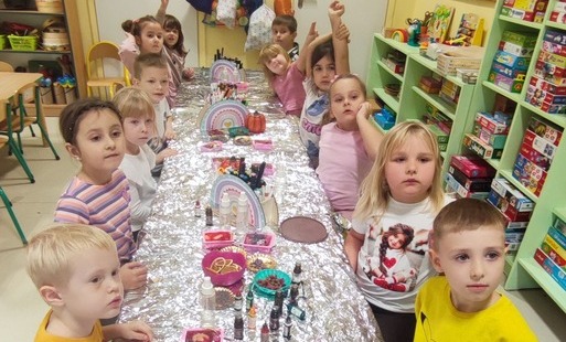 przedszkolaki siedzą przy stole podczas warsztatów mydlarskich